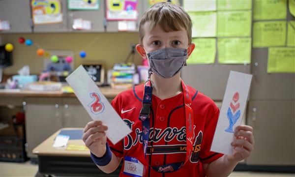 boy holds up product